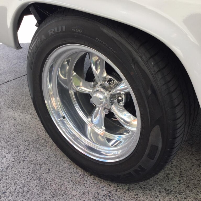 Ford pickup with American Racing Torq Thrust wheels in custom fitment and Nexen N'Fera RU1 tyres