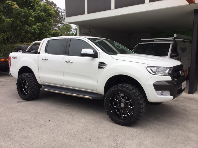Ford Ranger with 20-inch KMC Buck wheels in gloss black with milled edges, and Gladiator X-Comp tyres