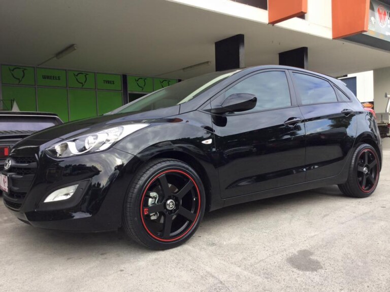 Hyundai I30 with 18-inch Motegi Racing MR116 wheels, matte black with red pinstripe