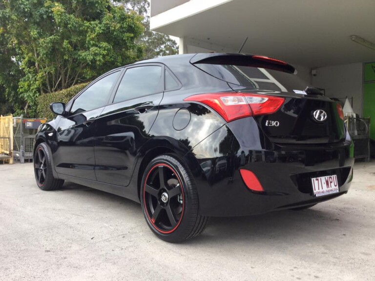 Hyundai I30 with 18-inch Motegi Racing MR116 wheels, matte black with red pinstripe