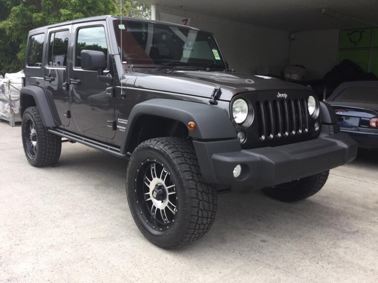 Lifted Jeep Wrangler with 20-inch KMC Riot wheels and Nitto Terra Grappler tyres