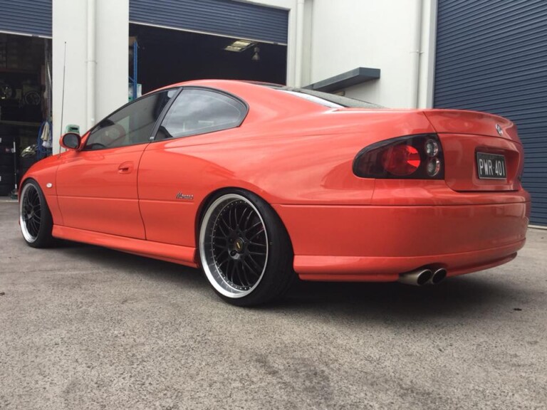 Monaro with 20-inch staggered Simmons OM wheels in gloss black with machined lip