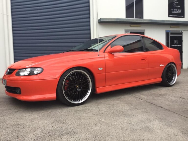 Monaro with 20-inch staggered Simmons OM wheels in gloss black with machined lip